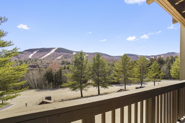 view of mountain backdrop with a heavily wooded area