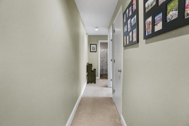 corridor featuring carpet floors, baseboards, and recessed lighting