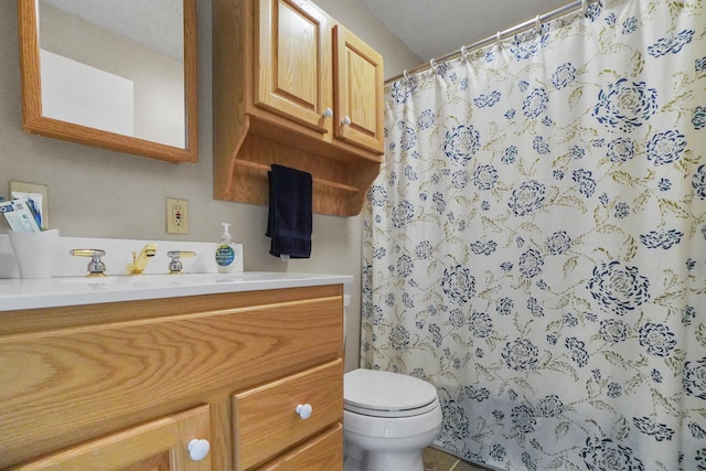 bathroom with toilet, vanity, and a shower with curtain