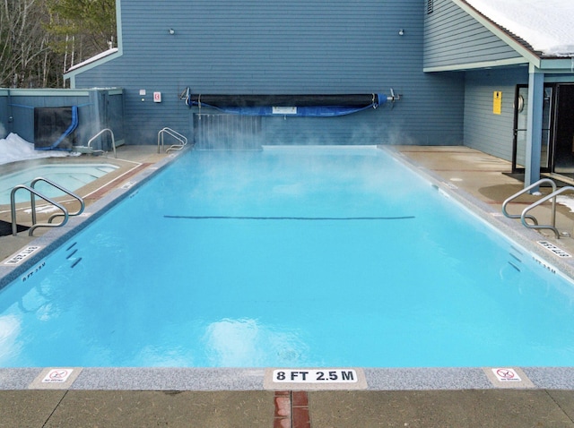 indoor pool featuring a patio