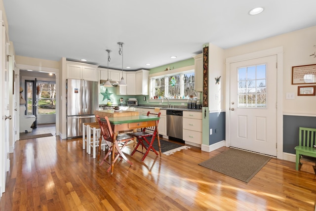 83 Barrett Hill Rd, Hope, ME 04847 - kitchen with appliances with stainless steel finishes, light wood-style flooring, recessed lighting, decorative light fixtures, and baseboards