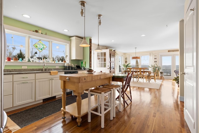 83 Barrett Hill Rd, Hope, ME 04847 - kitchen featuring a sink, wood finished floors, pendant lighting, recessed lighting, and dark stone countertops
