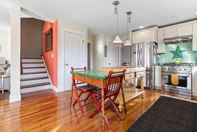 83 Barrett Hill Rd, Hope, ME 04847 - dining room with baseboards, light wood-style floors, stairway, and recessed lighting