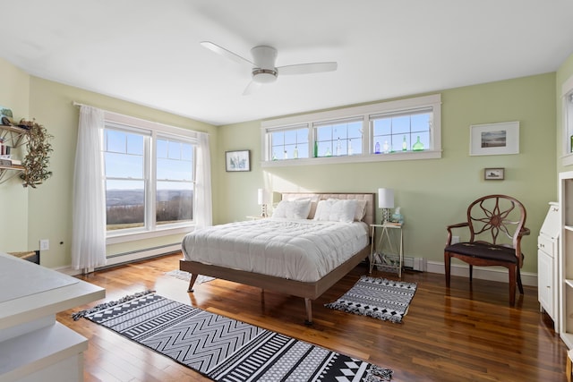 83 Barrett Hill Rd, Hope, ME 04847 - bedroom with a baseboard heating unit, wood finished floors, baseboards, baseboard heating, and ceiling fan