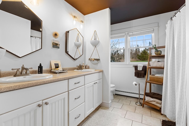 83 Barrett Hill Rd, Hope, ME 04847 - full bathroom with baseboard heating, toilet, tile patterned floors, and double vanity