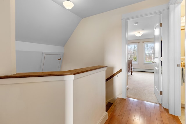 83 Barrett Hill Rd, Hope, ME 04847 - hall with an upstairs landing, baseboard heating, light wood-style floors, lofted ceiling, and baseboards