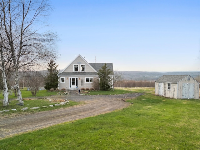 83 Barrett Hill Rd, Hope, ME 04847 - view of front of house featuring a storage shed, a front yard, an outdoor structure, and dirt driveway