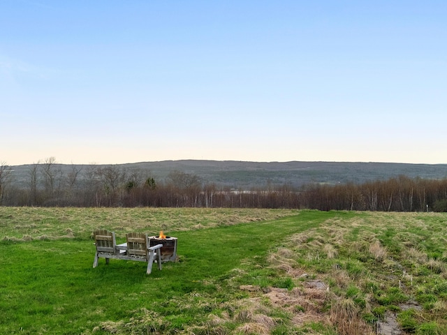 83 Barrett Hill Rd, Hope, ME 04847 - view of green lawn with a view of countryside and a fire pit