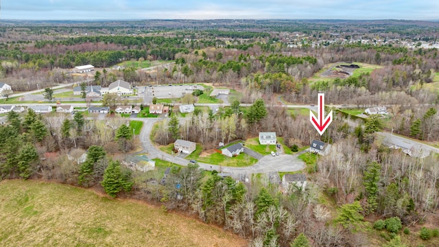 birds eye view of property featuring a wooded view