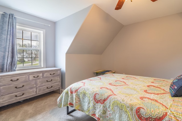 bedroom with carpet flooring, vaulted ceiling, and ceiling fan