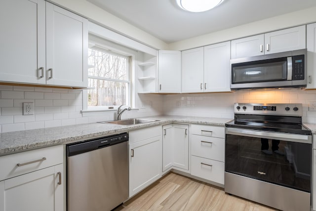 3 Great Pond Ter Unit 3, Cape Elizabeth, ME 04107 - kitchen featuring light wood finished floors, a sink, white cabinetry, open shelves, and stainless steel appliances