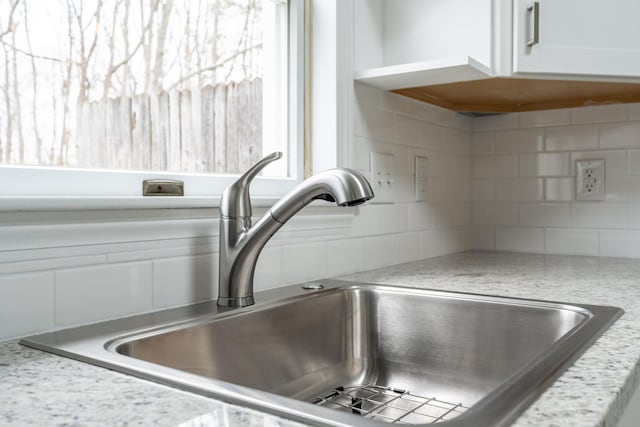 3 Great Pond Ter Unit 3, Cape Elizabeth, ME 04107 - interior details with backsplash, light stone countertops, white cabinetry, and a sink