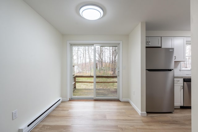 3 Great Pond Ter Unit 3, Cape Elizabeth, ME 04107 - kitchen with a baseboard heating unit, a wealth of natural light, light wood-style flooring, and appliances with stainless steel finishes