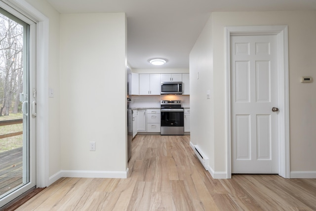 3 Great Pond Ter Unit 3, Cape Elizabeth, ME 04107 - kitchen featuring baseboard heating, light wood-style flooring, baseboards, white cabinets, and appliances with stainless steel finishes