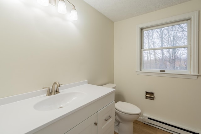 3 Great Pond Ter Unit 3, Cape Elizabeth, ME 04107 - bathroom with toilet, wood finished floors, a baseboard heating unit, vanity, and a textured ceiling
