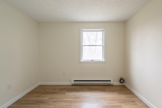 3 Great Pond Ter Unit 3, Cape Elizabeth, ME 04107 - spare room with light wood-style floors, baseboards, and a baseboard heating unit