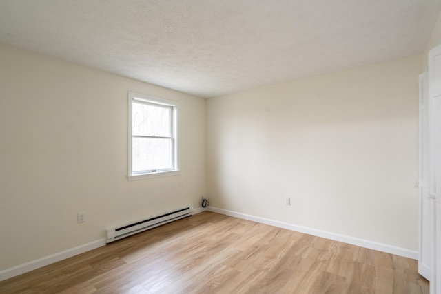 3 Great Pond Ter Unit 3, Cape Elizabeth, ME 04107 - spare room with a textured ceiling, light wood-style flooring, baseboards, and a baseboard heating unit