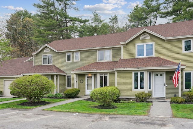 view of property with a shingled roof