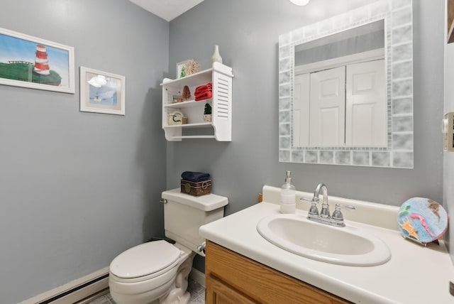 half bathroom with a baseboard radiator, toilet, and vanity