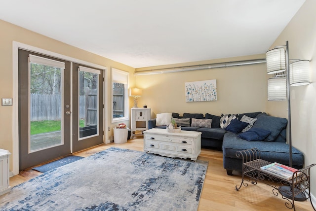 living area featuring light wood-style flooring and french doors