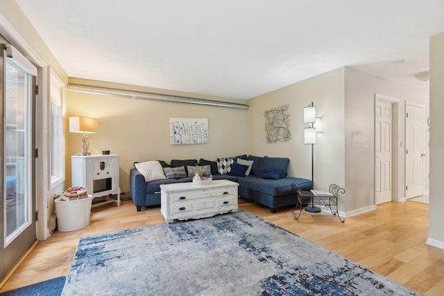 living area featuring wood finished floors and baseboards