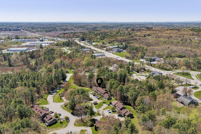 aerial view of property's location featuring a heavily wooded area