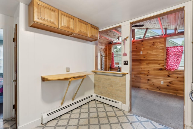 bar area with wooden walls and a baseboard radiator