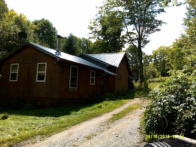 17 Kingsbury Rd, Wellington, ME 04942 - view of home's exterior featuring dirt driveway and metal roof