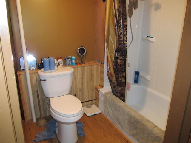 17 Kingsbury Rd, Wellington, ME 04942 - bathroom featuring toilet, wood finished floors, and shower / bathtub combination with curtain