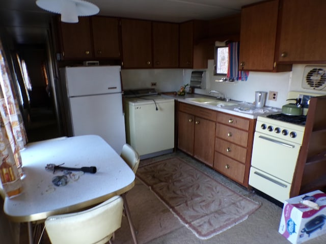 17 Kingsbury Rd, Wellington, ME 04942 - kitchen with washer / clothes dryer, white appliances, a sink, light countertops, and brown cabinets