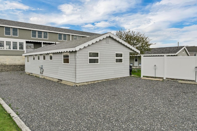 273 Webhannet Dr Unit 8, Wells, ME 04090 - rear view of house featuring roof with shingles and fence