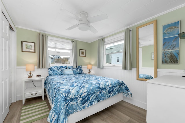273 Webhannet Dr Unit 8, Wells, ME 04090 - bedroom with wainscoting, wood finished floors, ornamental molding, ceiling fan, and a closet