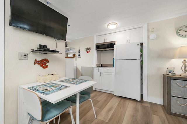 273 Webhannet Dr Unit 8, Wells, ME 04090 - kitchen featuring freestanding refrigerator, stainless steel microwave, white cabinetry, light wood finished floors, and open shelves