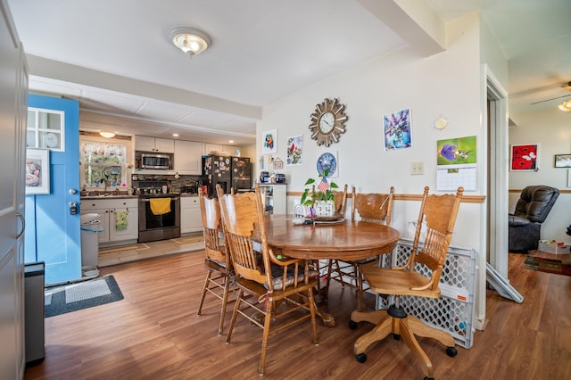 dining room with light wood-style floors and a ceiling fan