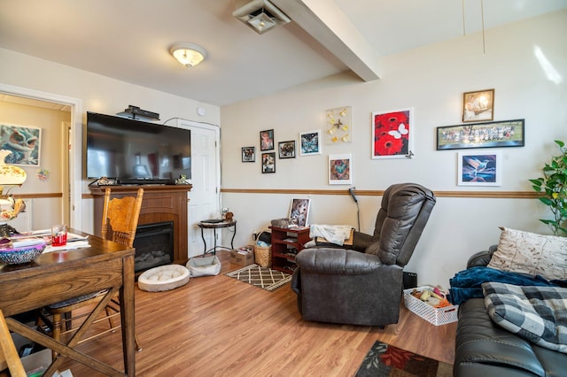 living area featuring light wood-style floors and a fireplace