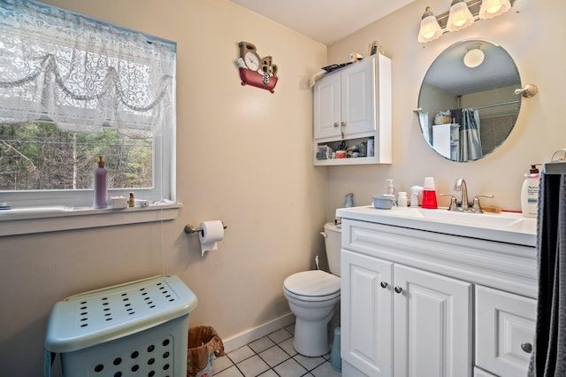 bathroom featuring tile patterned floors, toilet, baseboards, and vanity