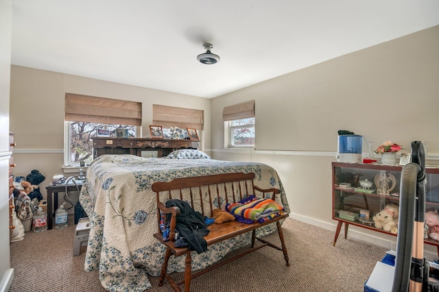 carpeted bedroom featuring baseboards