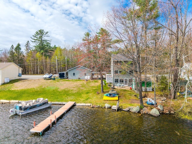 dock area featuring a water view and a lawn