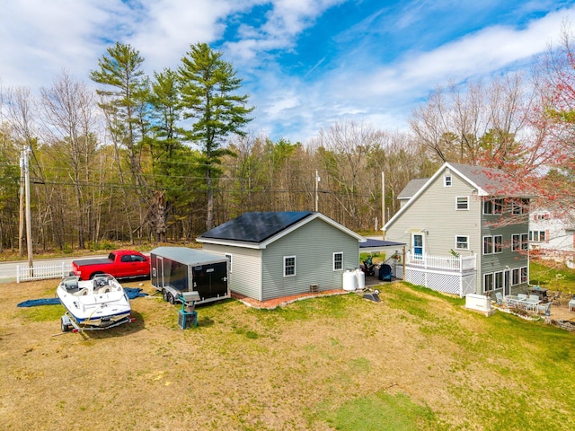 rear view of property featuring a lawn