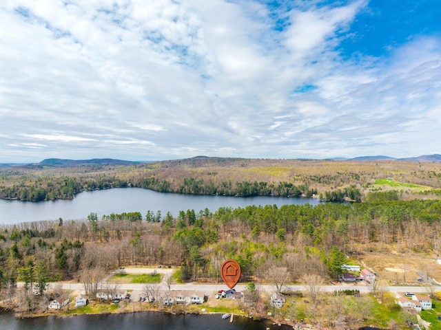 aerial view of property's location with a water and mountain view and a heavily wooded area