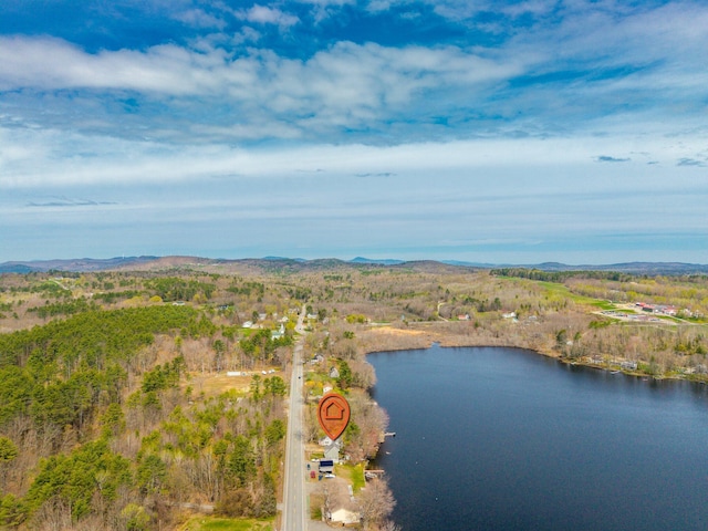 aerial view of property and surrounding area featuring a water and mountain view