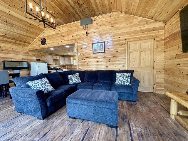 42 Cyrs Siding Rd, Saint Albans, ME 04971 - living area with vaulted ceiling, wood walls, wood ceiling, a chandelier, and wood finished floors