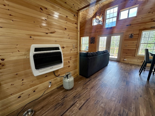 42 Cyrs Siding Rd, Saint Albans, ME 04971 - living area with heating unit, vaulted ceiling, a chandelier, french doors, and wood walls