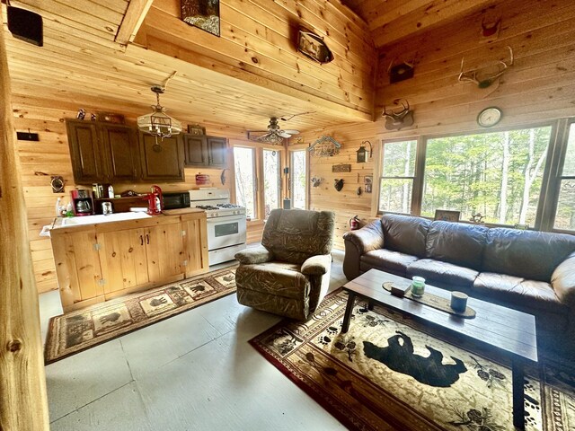 42 Cyrs Siding Rd, Saint Albans, ME 04971 - living room featuring wood walls, finished concrete floors, and ceiling fan