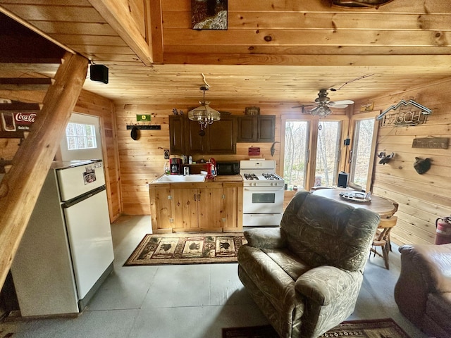 42 Cyrs Siding Rd, Saint Albans, ME 04971 - kitchen featuring white appliances, wood walls, a sink, wood ceiling, and ceiling fan