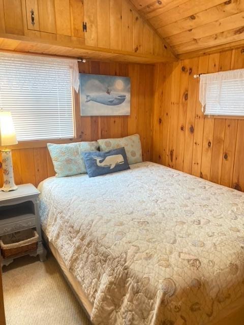 76 Post Rd Unit C9, Wells, ME 04090 - carpeted bedroom featuring vaulted ceiling, wood ceiling, wooden walls, and multiple windows
