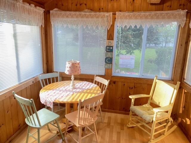 76 Post Rd Unit C9, Wells, ME 04090 - dining area with wooden walls and light wood-style floors