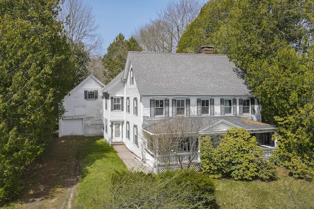 44 Pascal Ave, Rockport, ME 04856 - rear view of property featuring a chimney, roof with shingles, and a garage