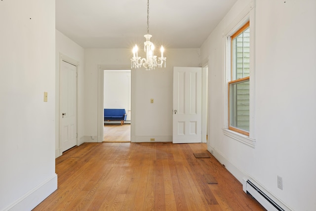 44 Pascal Ave, Rockport, ME 04856 - unfurnished dining area featuring a baseboard heating unit, a chandelier, light wood finished floors, and baseboards