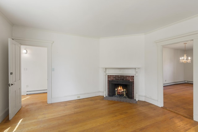 44 Pascal Ave, Rockport, ME 04856 - unfurnished living room featuring wood finished floors, a baseboard heating unit, a chandelier, crown molding, and a brick fireplace